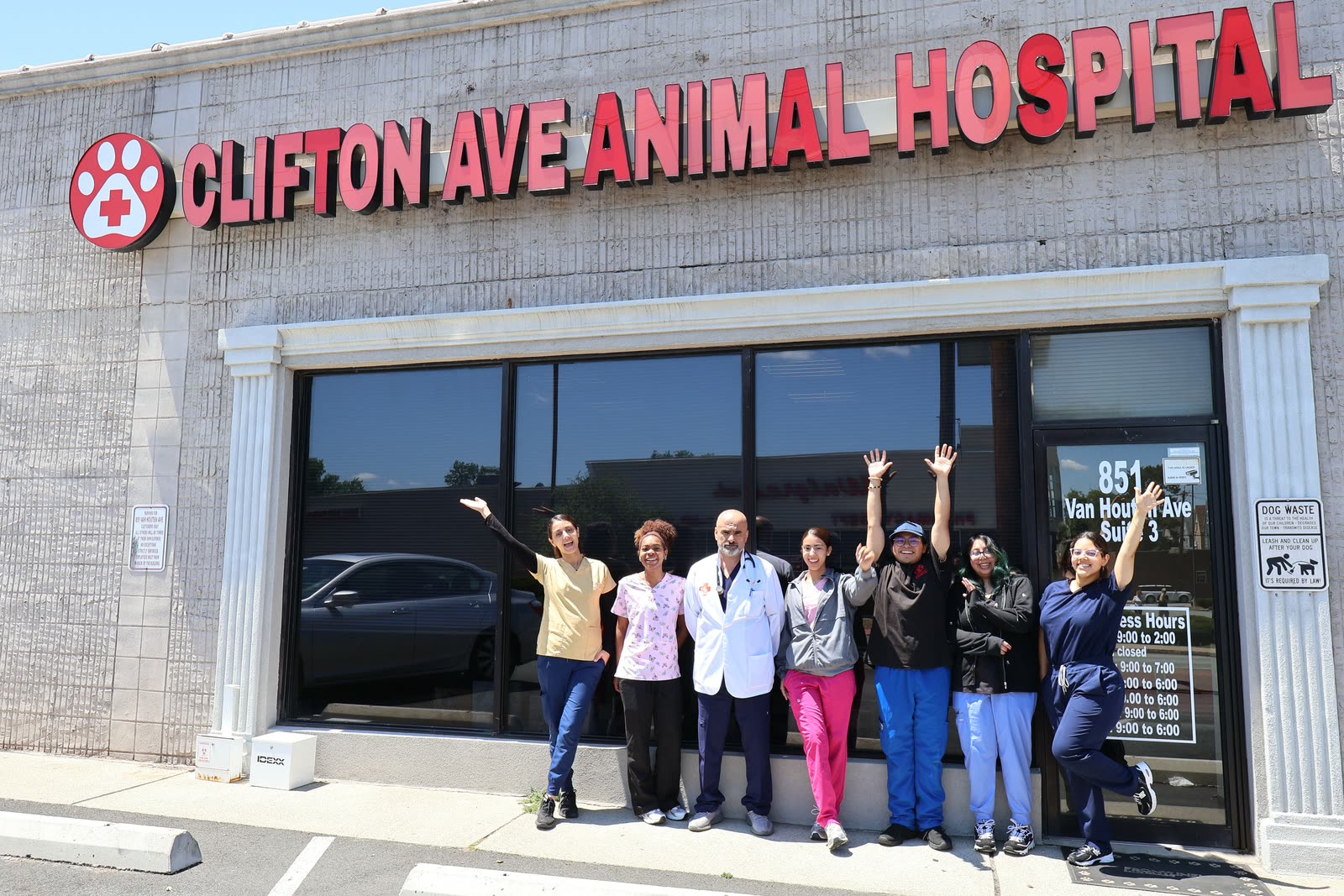 The Clifton Ave Animal Hospital team celebrating outside the hospital entrance