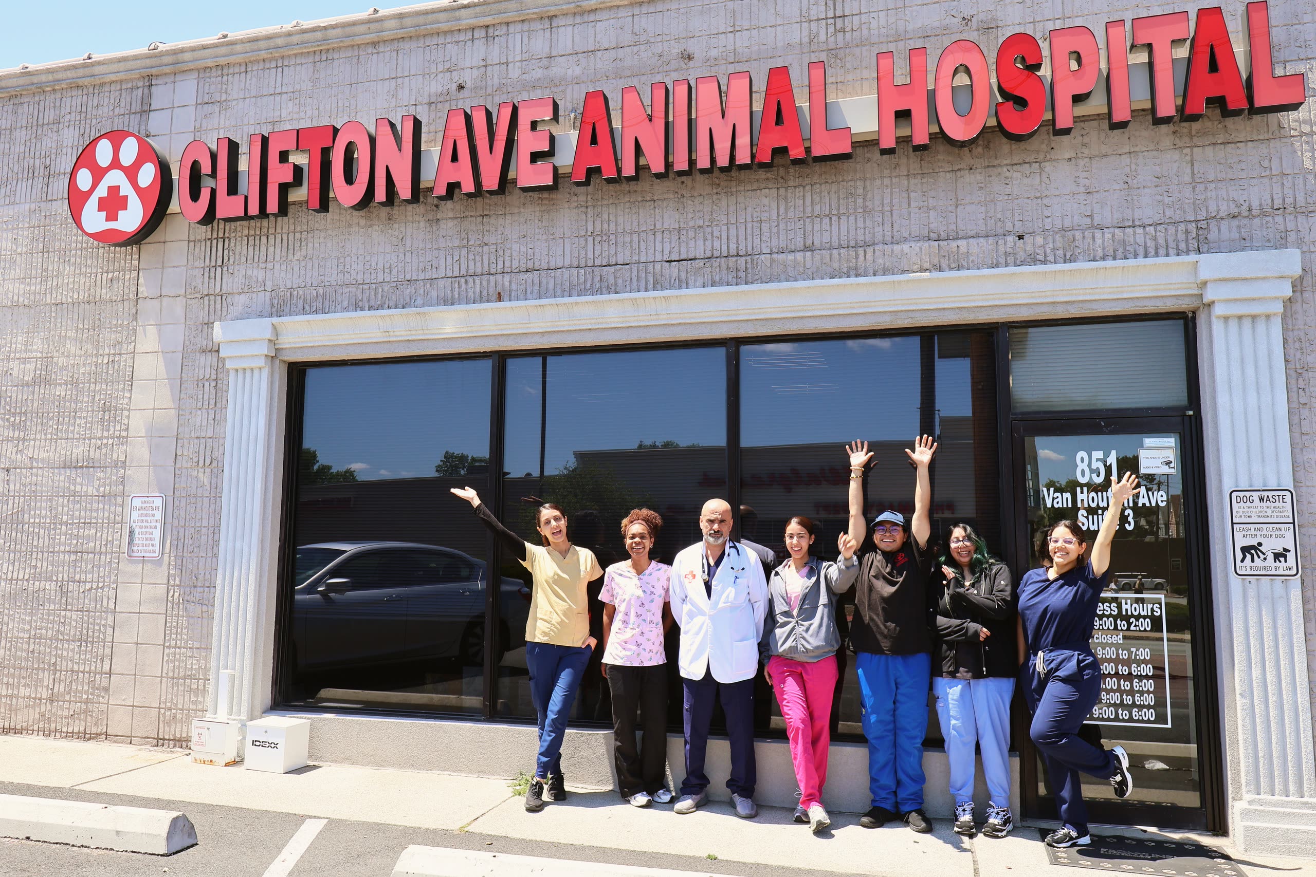 The Clifton Ave Animal Hospital team waving outside the clinic