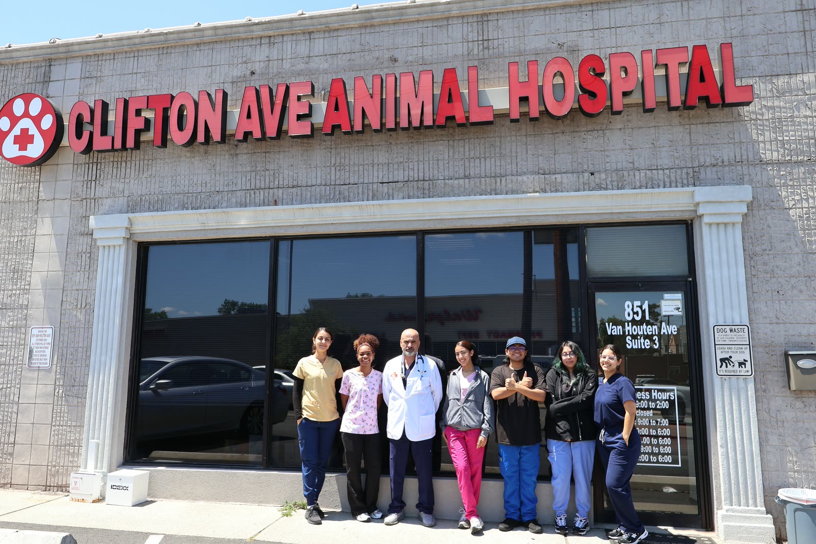 The Clifton Ave Animal Hospital team outside the hospital entrance at 851 Van Houten Ave